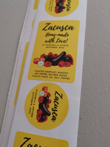 Yellow stickers with the text "Zatunska" and illustrations of fruits and flowers.
